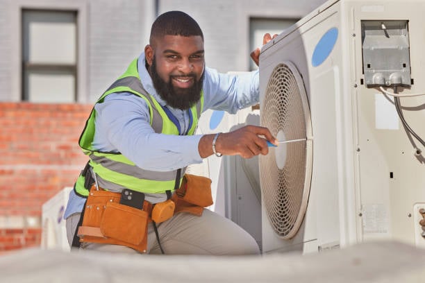 Friendly uniformed HVAC technician greeting a homeowner